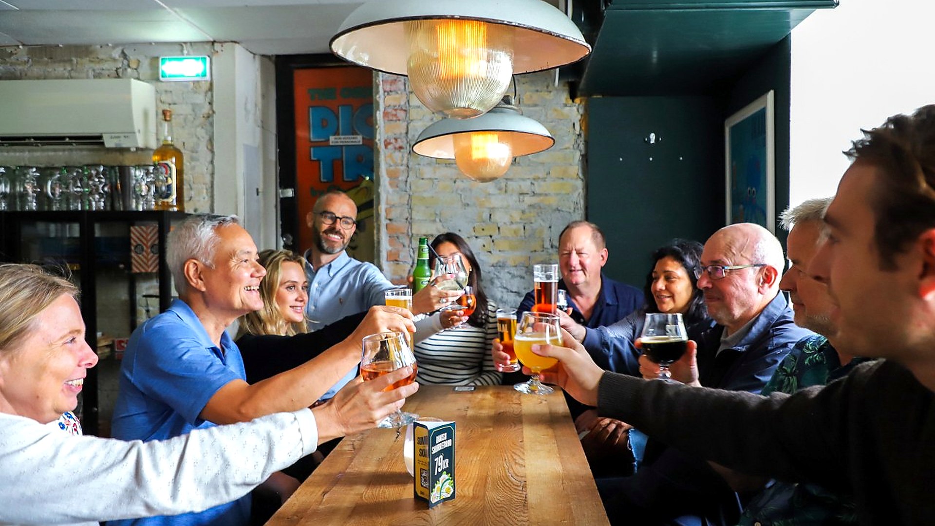 Guests sharing food and drinks around a Copenhagen restaurant table